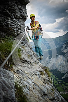 Pretty, female climber on a via ferrata