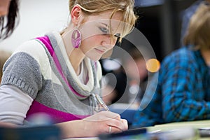 Pretty female college student in a classroom