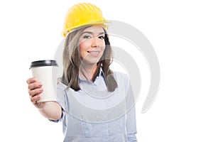 Pretty female constructor offering takeaway coffee photo