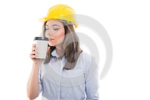 Pretty female constructor smelling takeaway coffee photo