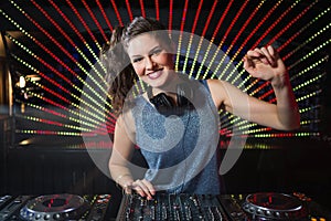 Pretty female DJ playing music