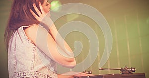 Pretty female DJ playing music