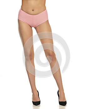 Pretty female legs in pink panties and high heels