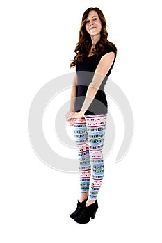 Pretty female model standing in colorful leggings