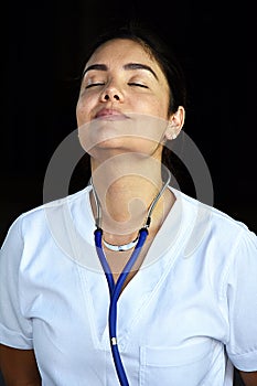 Pretty Female Nurse Stretching Wearing Scrubs
