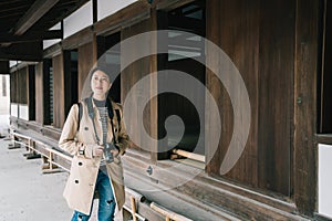 A pretty female photographer walking in temple