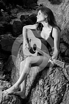 Pretty female singer playing guitar.