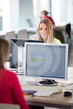 Pretty, female student looking at a desktop computer screen