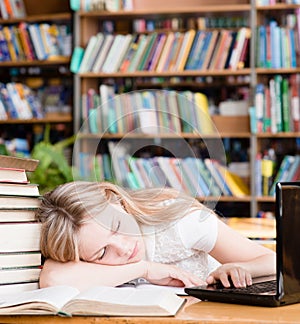 Pretty female student sleep in library