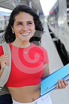 Pretty female student taking a train photo