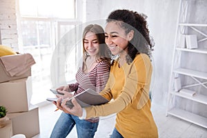 Pretty female students creating list of boxes