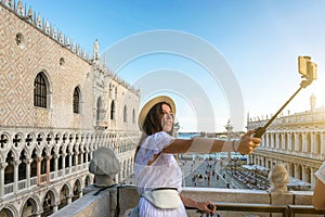 Pretty female taking fun self portrait photo in San Marco square in travel Europe city Italy, Venice. Panoramic view old Italian