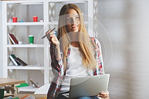 Pretty female using laptop at workplace