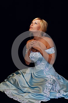 Pretty fiancee in blue dress looking at the sky