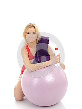 Pretty fitness woman exercise with pilates ball