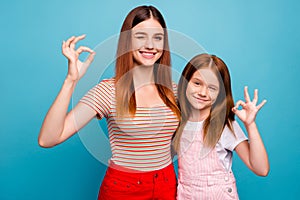 Pretty foxy small lady and her mom showing okey symbol wear casual clothes isolated blue background