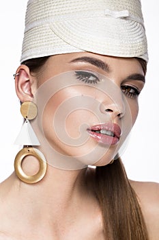 Pretty fresh girl, image of modern Twiggy in fashionable white hat, with unusual eyelashes and accessories.
