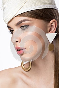 Pretty fresh girl, image of modern Twiggy in fashionable white hat, with unusual eyelashes and accessories.