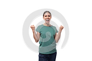 pretty friendly young caucasian brunette woman in green t-shirt rejoices and shouts