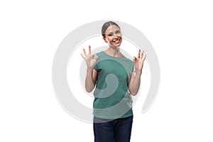 pretty friendly young caucasian brunette woman in green t-shirt on white background with copy space