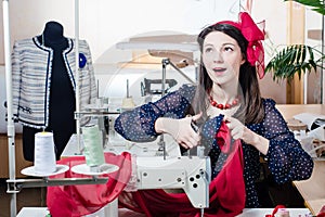 Pretty funny young pinup woman with sewing machine