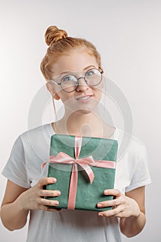 Pretty ginger girl with hairbun has got a gift box on Valentines day