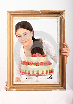 Pretty girl with anniversary cake in frame