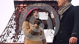 Pretty girl asking passers-by how to get to famous tower, language barrier