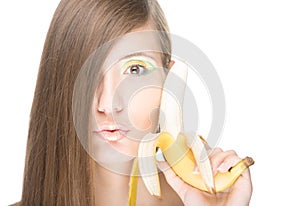 Pretty girl with banana isolated on white.