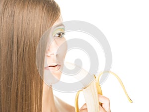 Pretty girl with banana isolated on white.