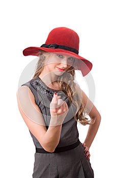 Pretty girl in big red hat wave to you isolated
