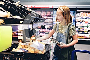 Pretty girl child shopping in supermarket