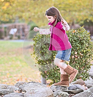 Pretty girl climbing on the rocks