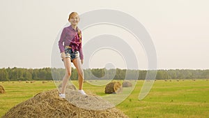 Pretty girl dance haystack mow crop straw coil