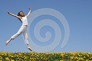 Pretty girl dancing in meadow