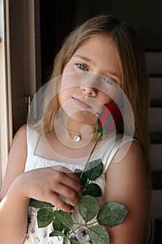 Pretty girl with diamond necklace and red rose