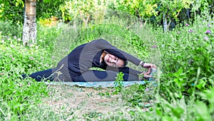 Pretty girl doing yoga exercises, little girl doing yoga exercises in the garden