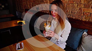 Pretty girl drinking ice cream cocktail at restaurant.