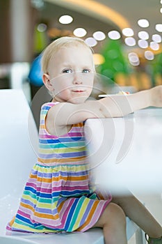 Pretty girl eating ice cream in cafe