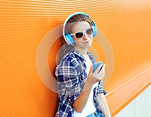 Pretty girl enjoys listen to music in headphones photo