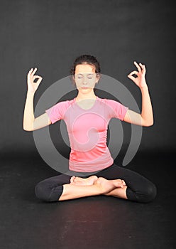 Pretty girl exercising yoga - lotus pose