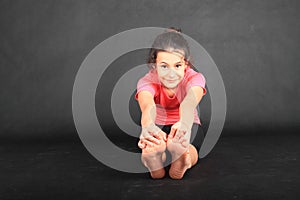 Pretty girl exercising yoga - seated forward fold