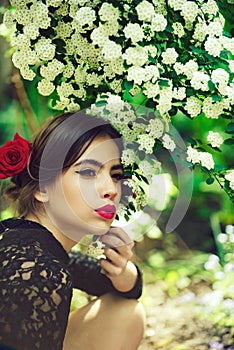 Pretty girl with fashionable spanish makeup, rose flower in hair