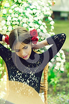 Pretty girl with fashionable spanish makeup, rose flower in hair