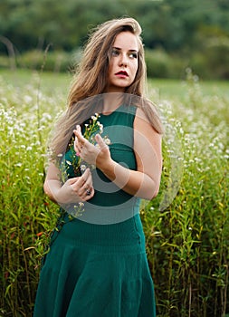 Pretty girl with flowers in her hand