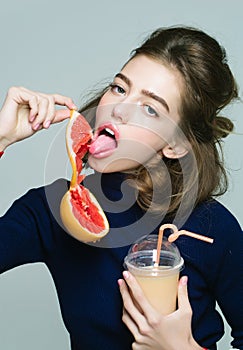 Pretty girl with grapefruit juice