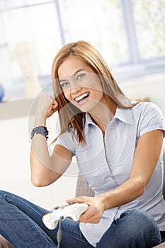 Pretty girl having fun with computer game laughing