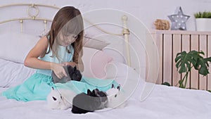 Pretty girl having fun, hugging and playing with decorative rabbit