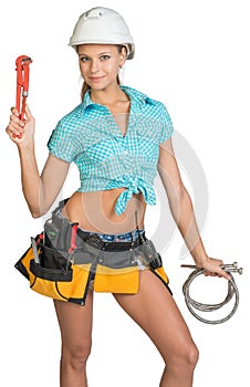 Pretty girl in helmet, shorts, shirt, tool belt