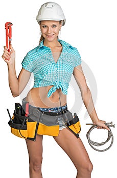 Pretty girl in helmet, shorts, shirt, tool belt
